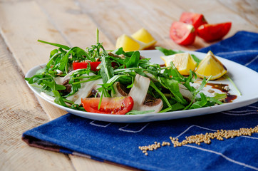 Fresh light salad with arugula , mushrooms, tomato in lemon-honey sauce. Healthy eating concept. proper nutrition