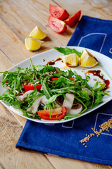 Fresh light salad with arugula , mushrooms, tomato in lemon-honey sauce. Healthy eating concept. proper nutrition