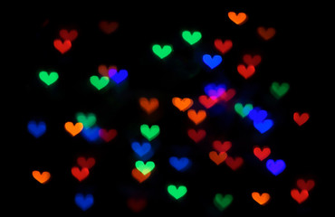 abstract multicolored lights background with bokeh hearts