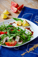 Fresh light salad with arugula , mushrooms, tomato in lemon-honey sauce. Healthy eating concept. proper nutrition