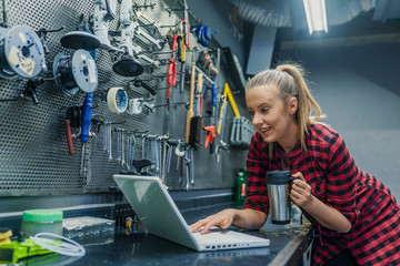 Woman mechanic working on a laptop
