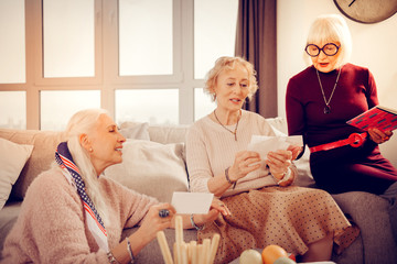 Joyful nice aged women remembering their youth