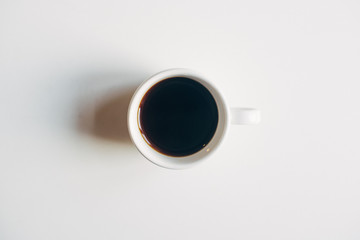 Cup of Black Coffee on a White Table - 247033644