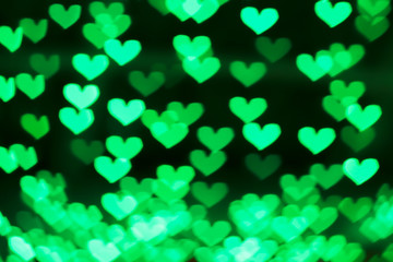 Green background with bokeh hearts