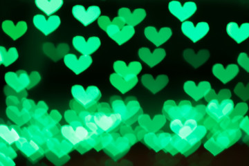 Green background with bokeh hearts