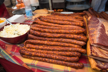 traditional smoked pork sausages lined up next to each other at the village fair