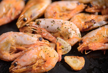 Cooking fried Shrimps on pan with spices close-up