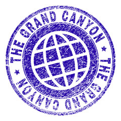 THE GRAND CANYON stamp print with distress texture. Blue vector rubber seal print of THE GRAND CANYON text with unclean texture. Seal has words placed by circle and planet symbol.