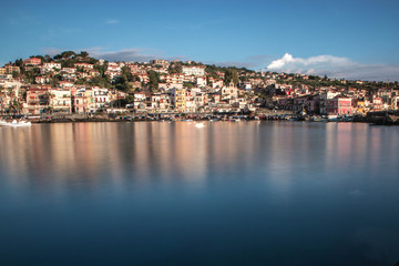 Obraz premium Splendid old fishing village in Sicily, Acitrezza with a view of the Volcano Etna