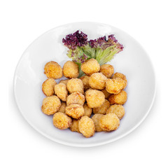 Chicken meatballs with lettuce on a plate isolated on white background