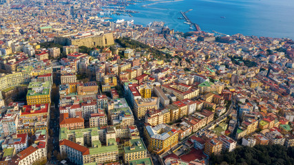 Obraz premium Aerial view of Naples from the Vomero district. You can see Castel Sant'elmo in the foreground while in the background the city's port and the Ovo castle. There are houses and buildings.