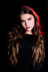 High Fashion model woman in red bright lights posing, portrait of beautiful girl with trendy make-up. Art design, colorful make up. Over black background. Close up portrait.