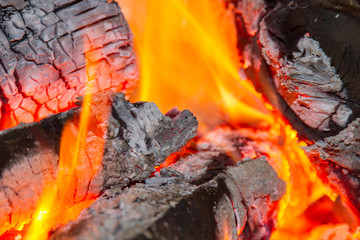 Home fireplace with beautiful orange fire and wood fire close. Burning fire in the fireplace. Logs...