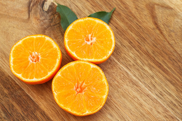 Creative orange background. Sliced oranges on wooden background. Copy space. Close-up. Top view.