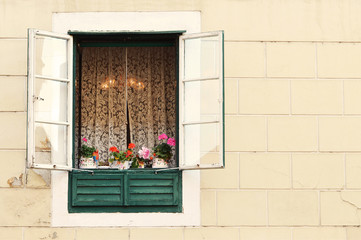Fototapeta na wymiar Old window with flowerpots