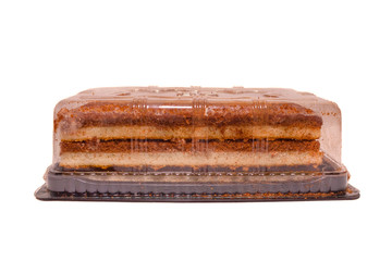 Chocolate cake in packaging on white isolated background