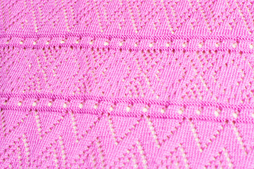 Texture of knitted pink fabric.