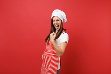Housewife female chef cook or baker in striped apron white t-shirt toque chefs hat isolated on red...