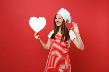 Housewife female chef cook or baker in striped apron, white t-shirt, toque chefs hat isolated on...