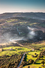 Fototapeta premium Sicilian countryside at sunset, cultivated fields and infrastructure