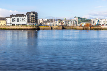 Fototapeta na wymiar Galway harbour, Corrib river and Galway buildings with reflection