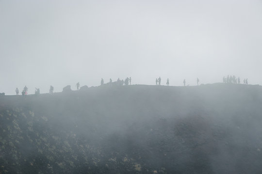 Excursion in the Silvestri crater, Volcano Etna and people in the fogh