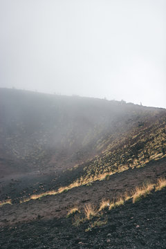 Excursion in the Silvestri crater, Volcano Etna and people in the fogh