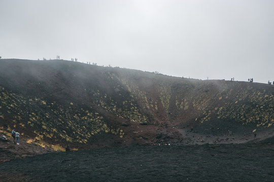 Excursion in the Silvestri crater, Volcano Etna and people in the fogh