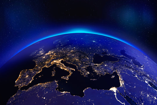 Europe at night from space with glowing city lights - Elements of this image furnished by NASA