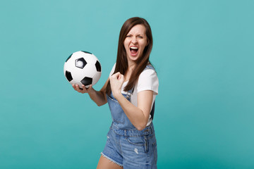 Screaming wild young woman football fan cheer up support favorite team with soccer ball doing...
