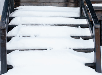 High angle view of snow covered brown  wooden stairs during winter