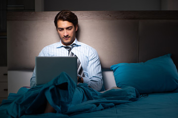 Tired businessman working overtime at home at night
