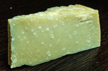 Italian parmesan cheese wood background