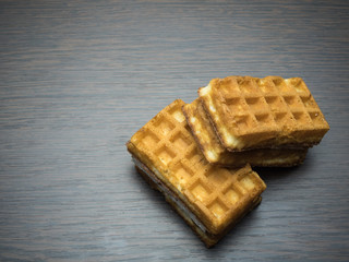 Soft waffles on wood background