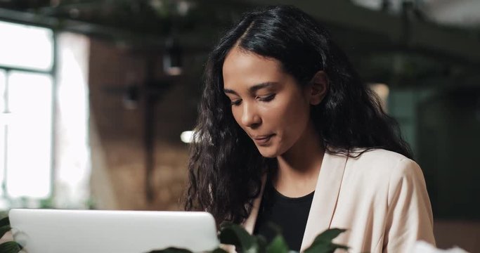 Experienced business woman working with laptop computer making research for planning startup at desktop,female secretary checking mail on netbook organizing working process in office