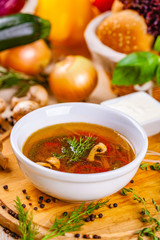 Vegetable soup with herbs and spices in white plate