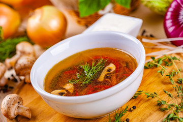 Vegetable soup with herbs and spices in white plate