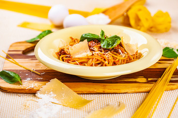 Spaghetti bolognese with minced meat and parmesan cheese in beige plate
