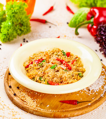 Rice with vegetables in white plate on wooden cutting board