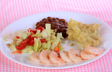 Shrimp sauteed in butter and garlic with baked beans and potatoes.