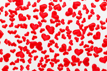 Valentines day background red hearts on white wooden background.