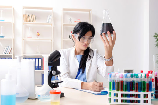 Female chemist working at the lab  