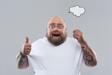 Excited man holding thought cloud and putting thumb up