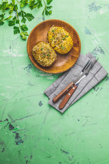 Portion baked potatoes in wooden plate with green onion and cheese