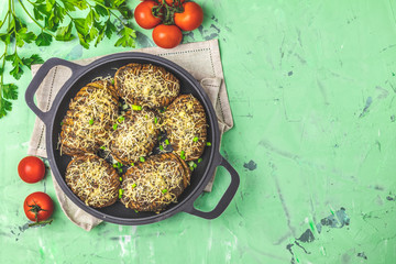 Portion baked potatoes in black frying pan