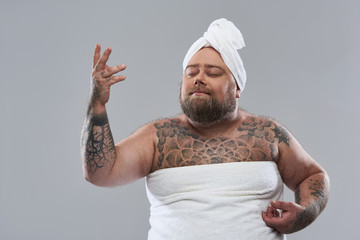Funny bearded man putting his hand up and looking dreamy