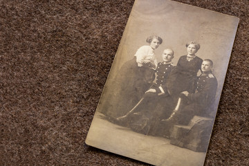 Portrait of officers and their girlfriends in period of World War I on trench coat background