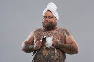 Waist up of confident shirtless man being ready for shower