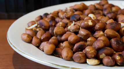 Roasted Peanuts Snack in White Plate in Wooden Backgrounds - topview ans Closeup