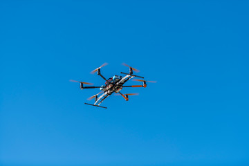 Fototapeta na wymiar Professional drone flying with landing gear retracted
